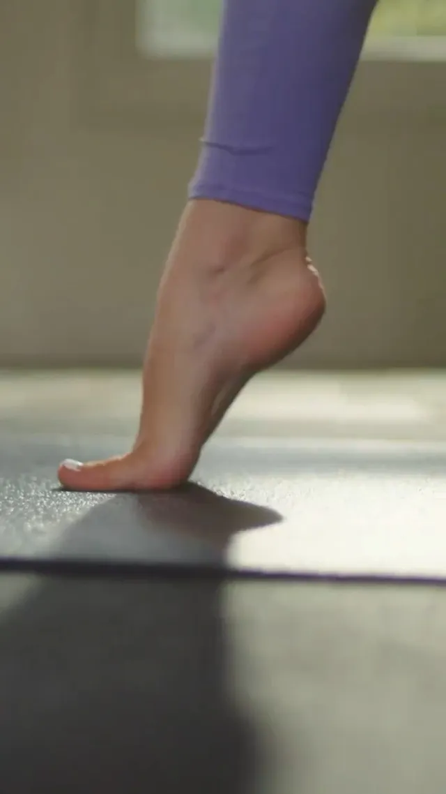 Olivia Dunne: close view of a bare foot raised onto its toes.