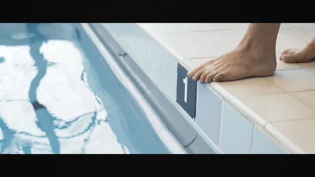 Nathalie Emmanuel standing at the edge of a swimming pool.