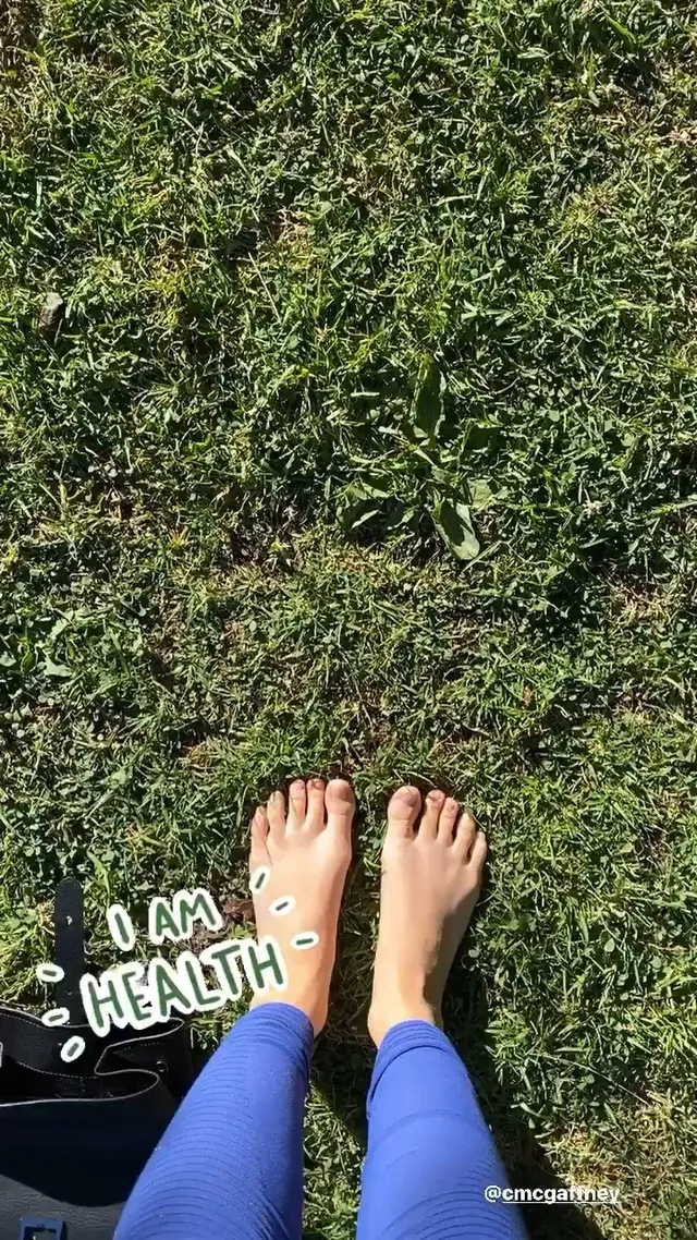 María Gabriela de Faría standing barefoot on a lawn.