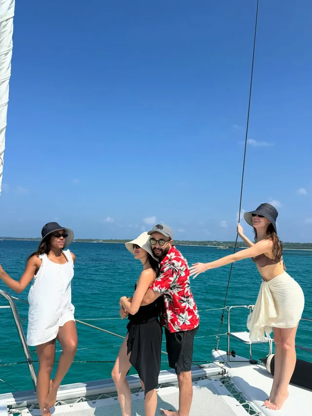 Alycia Debnam-Carey standing with companions on the deck of a boat.
