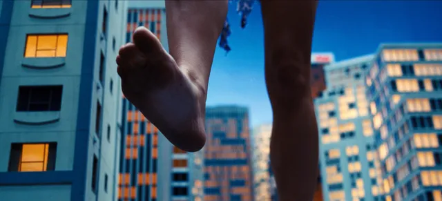 Sydney Sweeney in a cropped action-film still showing bare feet against city buildings.