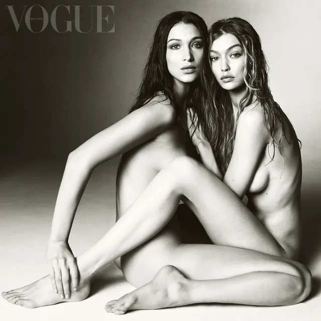 Gigi Hadid sitting barefoot beside a guest for a monochrome portrait.