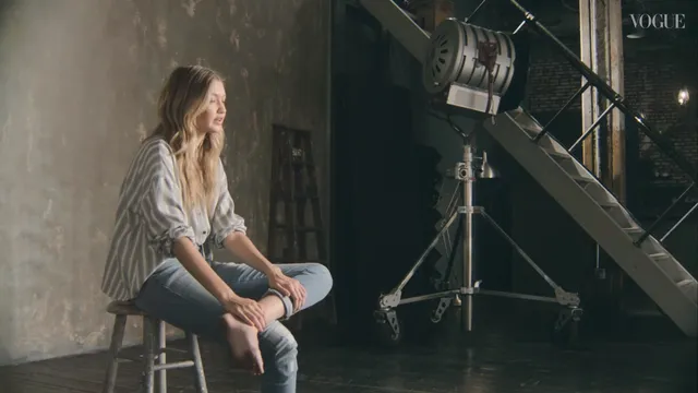Gigi Hadid sitting barefoot during a studio interview.