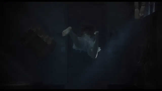Léa Seydoux swimming underwater in a screen scene.