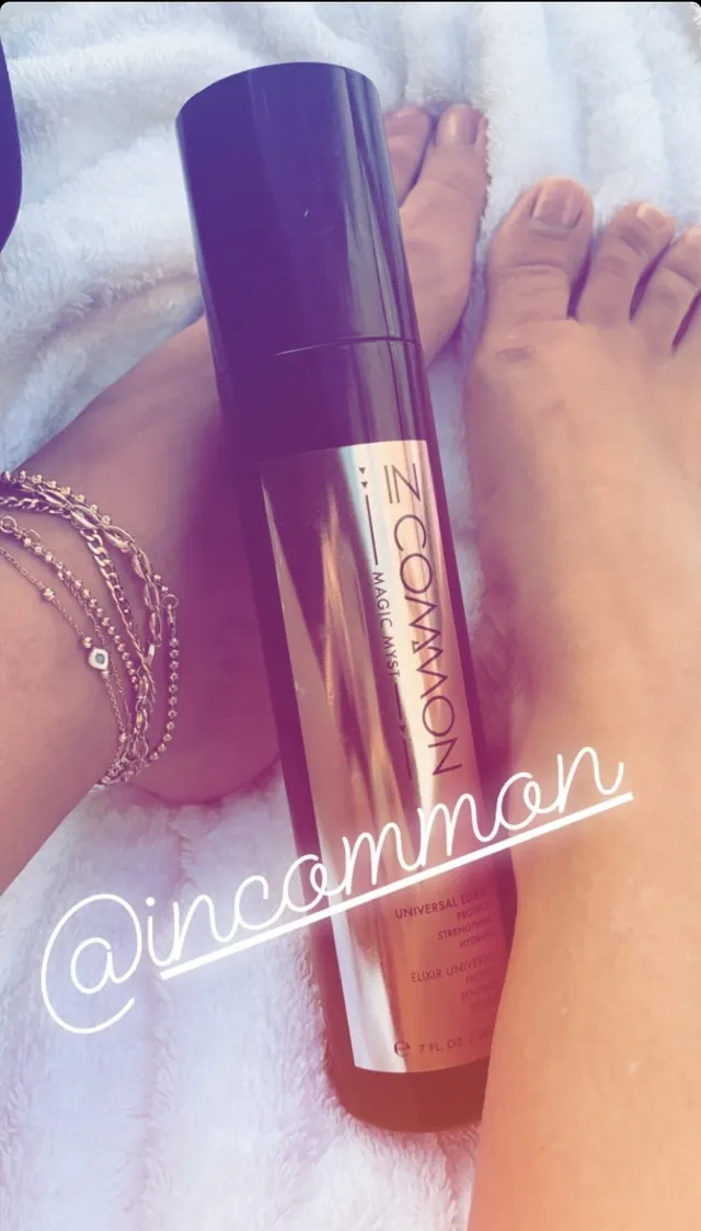 Sarah Hyland a casual view of bare feet beside a cosmetics product.