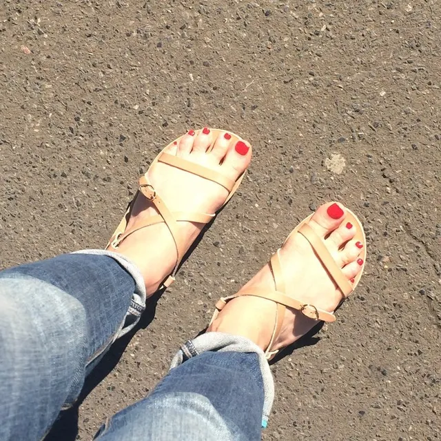 Gemma Arterton wearing pale flat sandals with jeans.
