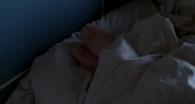 Jennifer Garner resting during a dimly lit screen scene.