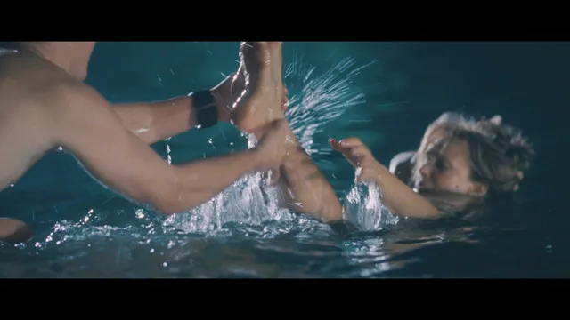 Rachel McAdams with heels raised above water in a screen image.