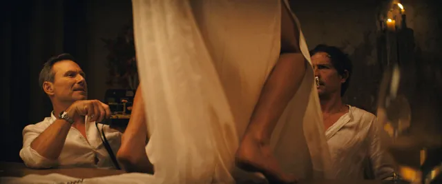 Adria Arjona with a bare foot raised in an indoor film scene.