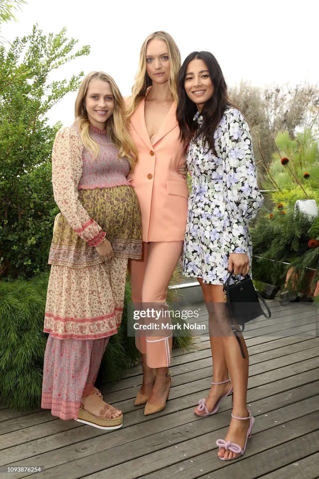 Teresa Palmer posing with companions at an outdoor event.