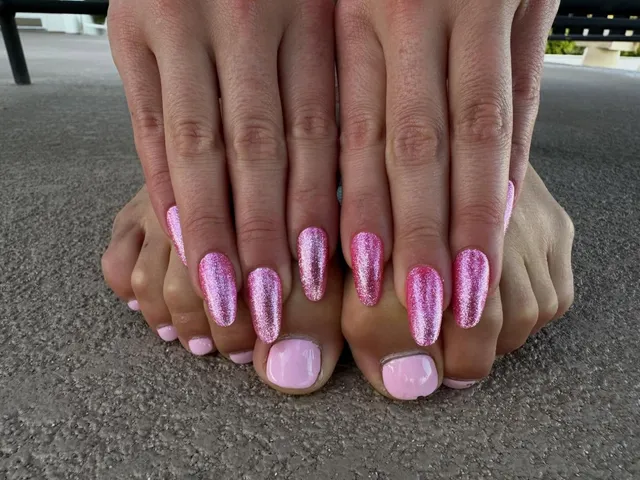 Addison Rae showing toes with pale polish beside manicured hands.