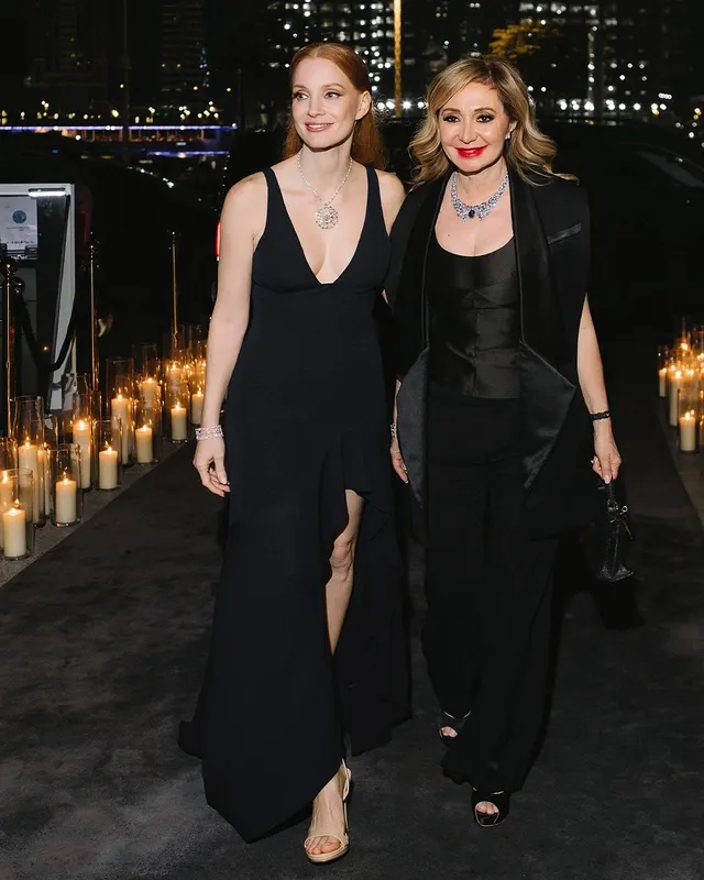 Jessica Chastain posing beside another guest in a black evening dress.