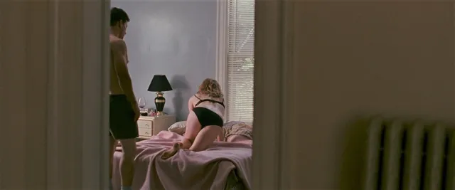 Amy Adams sitting on a bed during a screen scene.