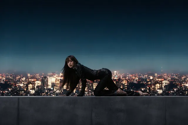 Lisa (Lalisa Manobal) posing on a rooftop in dark heels and a black outfit.