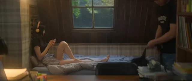 Bae Suzy lying barefoot on a bed in a scene.